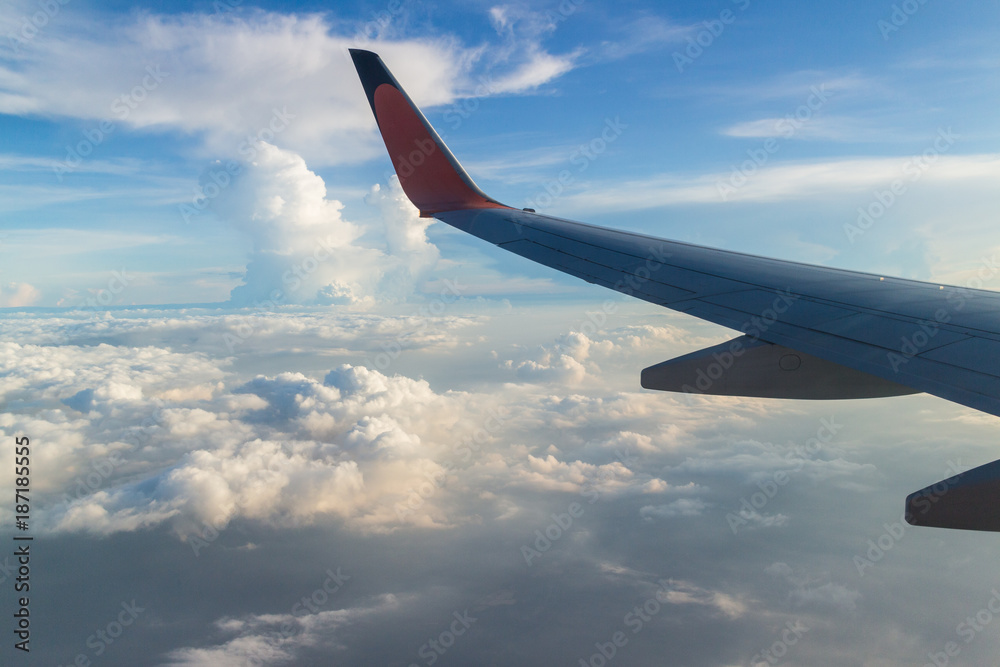 Fototapeta premium View from the wing of the plane Fly over the clouds in the sky.
