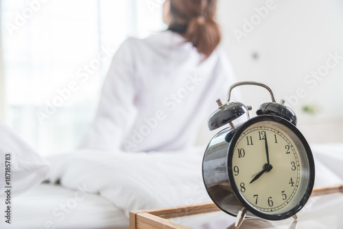 Young woman lying in bed in morning