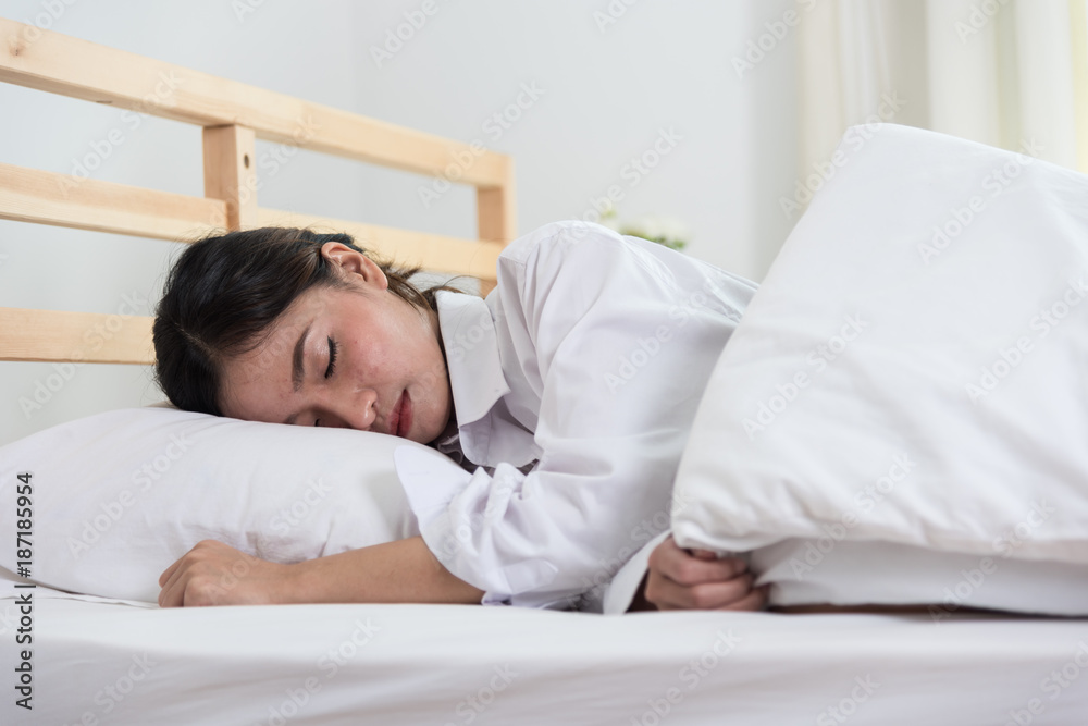 Beautiful young woman sleeping on white bed Beautiful young woman sleeping on white bed