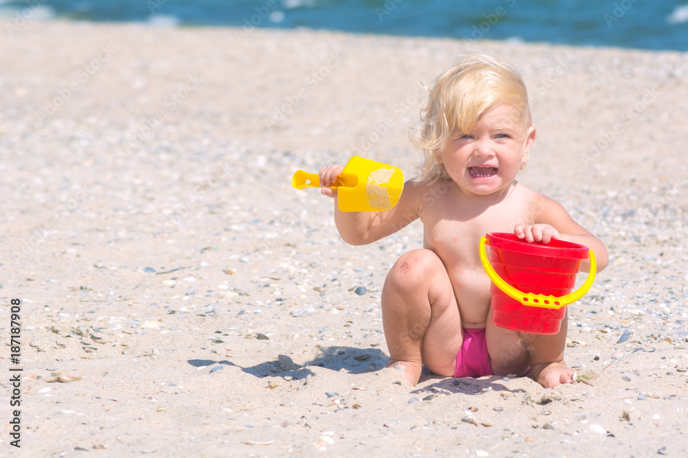 Cute funny little girl playing with toy buckets Cute funny little girl playing with toy buckets