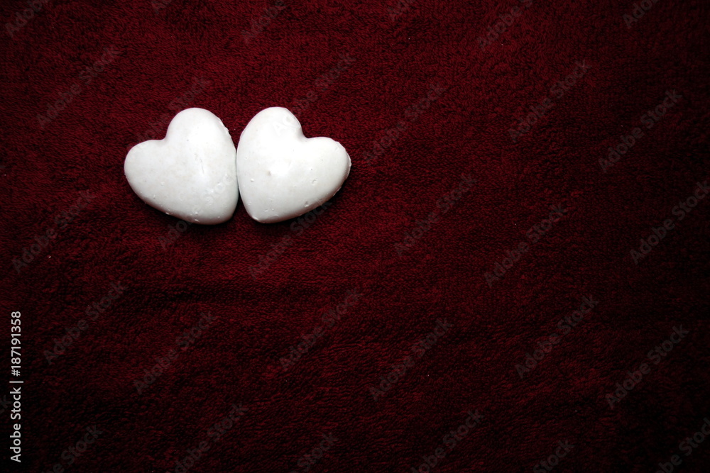 Obraz premium Valentine`s day concept with two hearts together on dark red background
