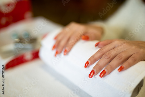 Woman getting nails done in a nail salon