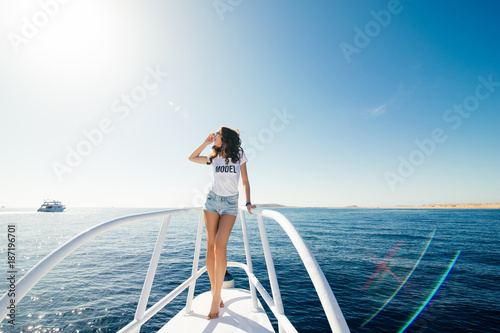 Young beautiful woman sitting on the yacht . Cruise vacation. © F8  \ Suport Ukraine