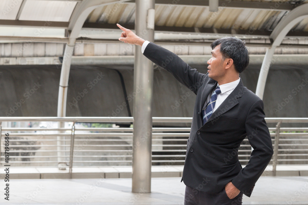 Businessman pointing to the target and mission and look up to the sky Businessman pointing to the target and mission and look up to the sky