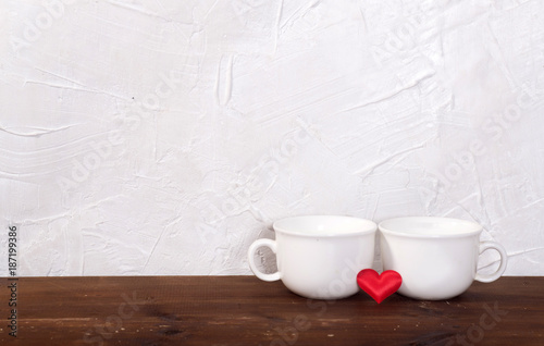 Valentine's day holiday celebration with hearts and cups over bokeh background