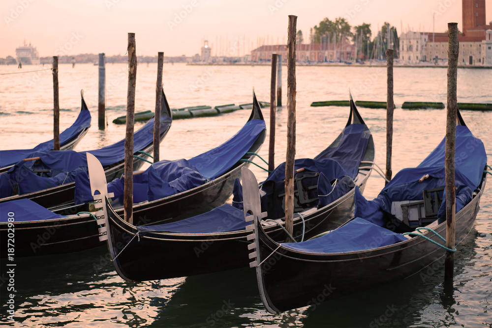 The moored gondolas in San Marco bay in the early cloudy morning. Venice, Italy