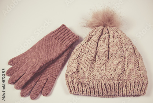 Wool hat and gloves for winter weather on a white background.