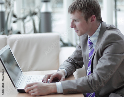 Young employee looking at computer monitor during working day