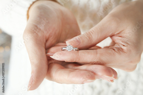 Woman holding luxury engagement ring, closeup