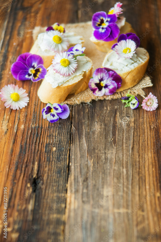 Sandwich with herb and edible flowers butter on marble cutting board. Healthy food. Sandwich with herb and edible flowers butter on marble cutting board. Healthy food.