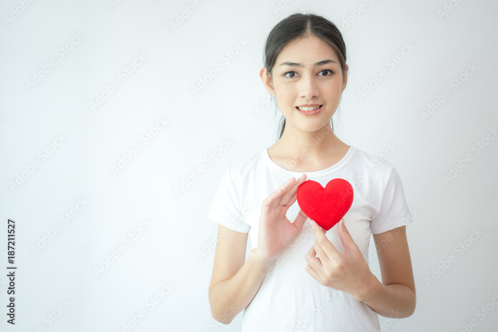 Asian woman holding red heart with attractive smiling on white background. Asian woman holding red heart with attractive smiling on white background.