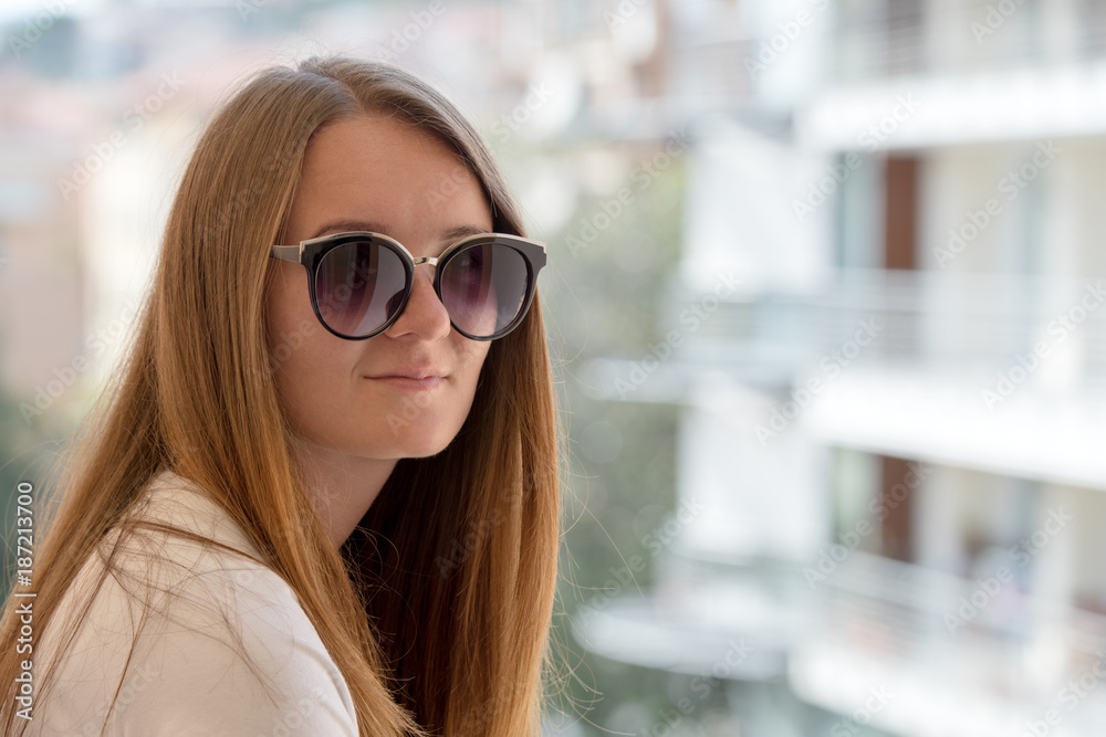 Portrait of young woman in stylish sunglasses Portrait of young woman in stylish sunglasses