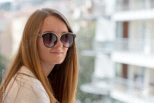 Portrait of young woman in stylish sunglasses