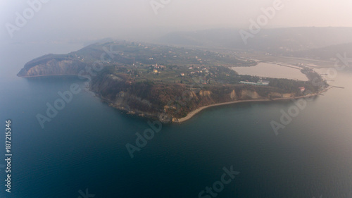 Aerial view of cliffs raising above sea.