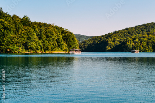 Lake with sailing ships with tourists in the Park, Plitvice Lakes, Croatia