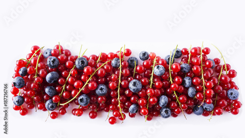Ripe blueberries and red currants mint isolated on a white. Berries at border of image with copy space for text. Red and blue berries. Various fresh summer berries on white background.