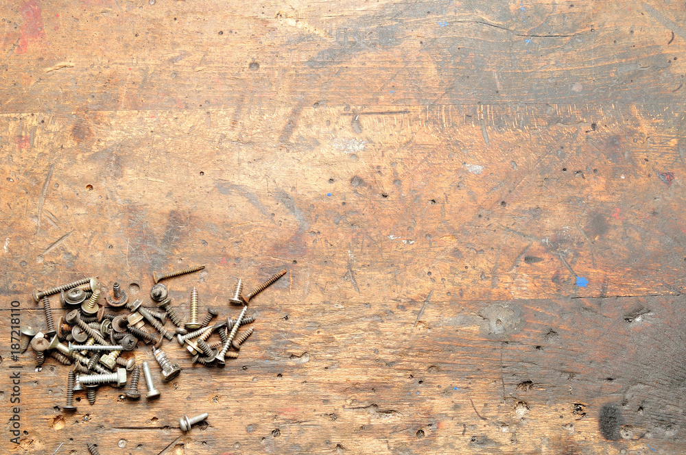 Old used dirty workbench with screws for background. - obrazy, fototapety, plakaty 