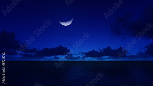 a crescent moon in the night ocean