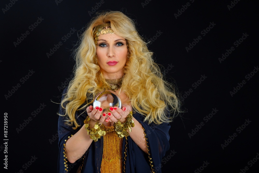 Woman fortune teller with crystal ball portrait on black Woman fortune teller with crystal ball portrait on black