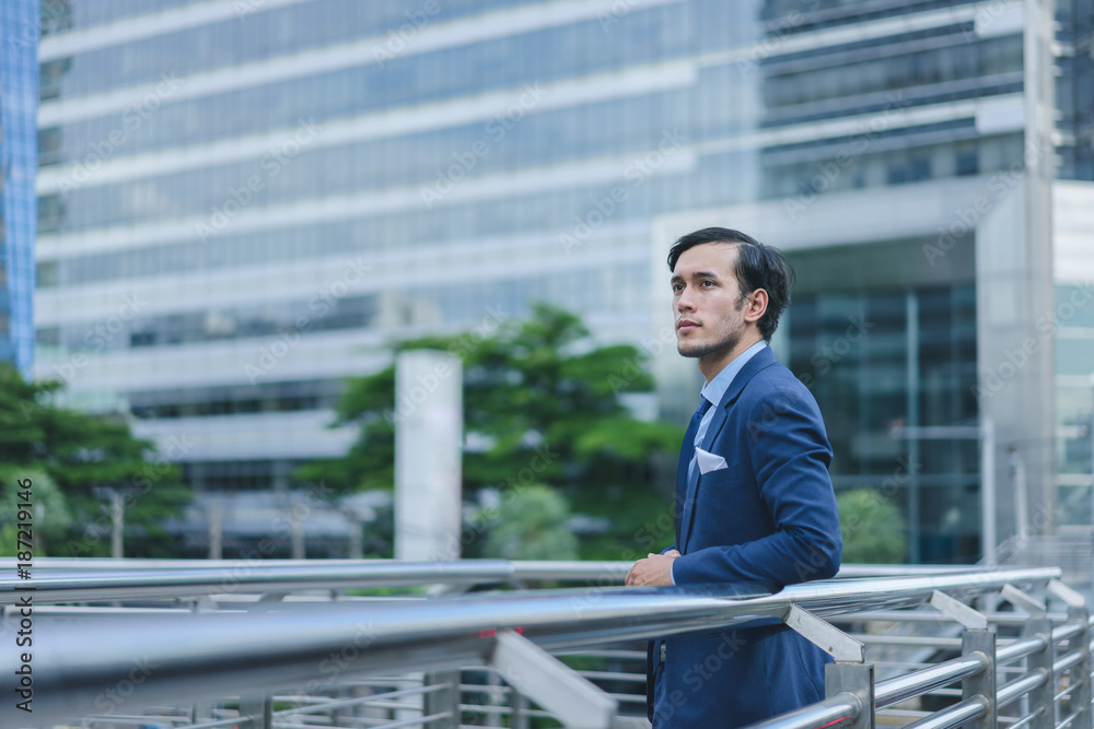 Smart businessman in full suit standing outdoors in cityscape background Smart businessman in full suit standing outdoors in cityscape background
