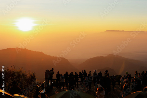 people are watching the first light from the sunset at DOI ANGKANG, Thailand