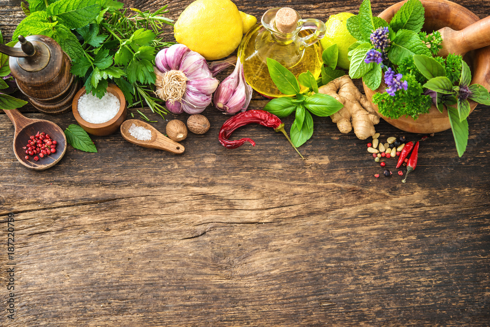 Fresh herbs and spices on wooden table