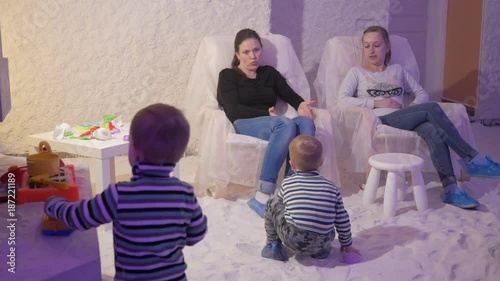 Young mothers with young sons rest in a salt room. Prevent respiratory problems