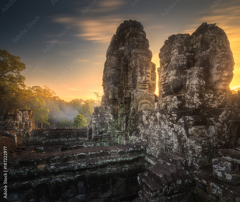 Fototapeta premium Sunrise view of ancient temple Bayon Angkor with stone faces Siem Reap, Cambodia