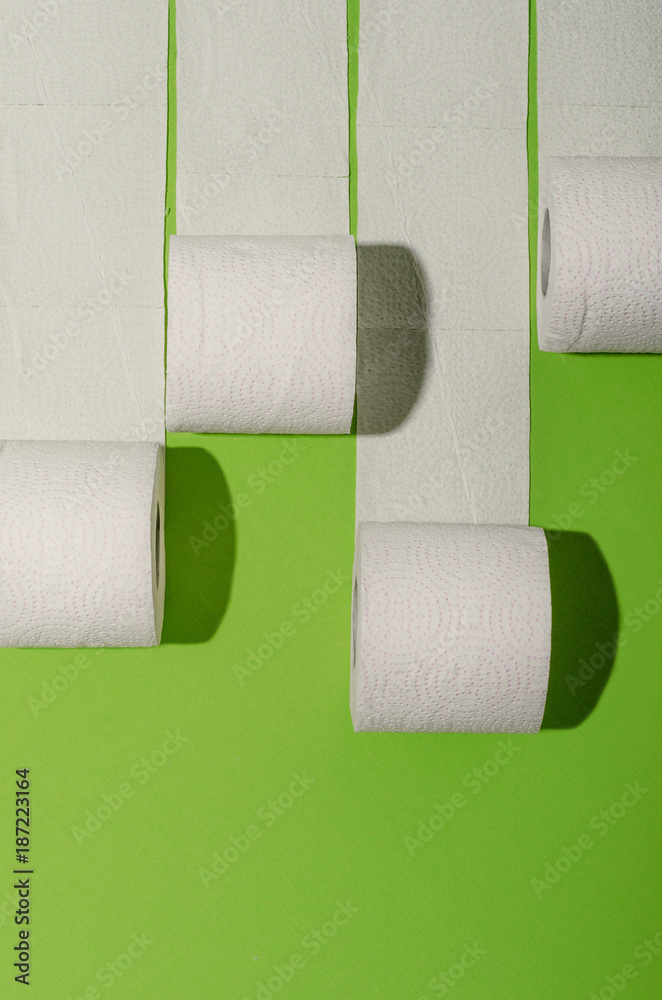 Obraz premium Toilet paper concept on green background. Hygiene and health. Concept photo.
