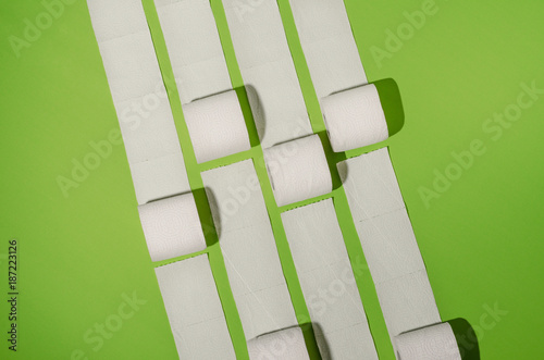 Toilet paper concept on green background. Hygiene and health. Concept photo.