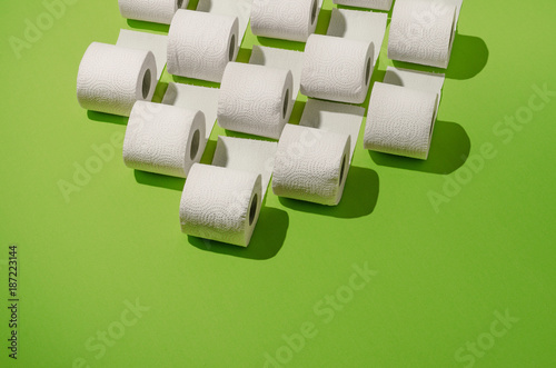 Toilet paper concept on green background. Hygiene and health. Concept photo.