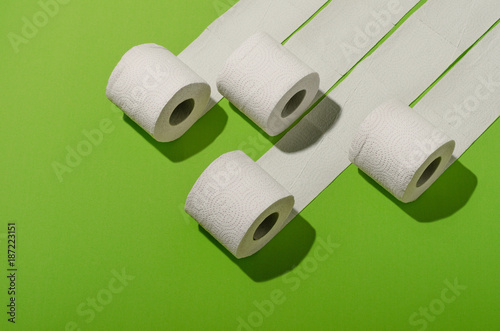 Toilet paper concept on green background. Hygiene and health. Concept photo.