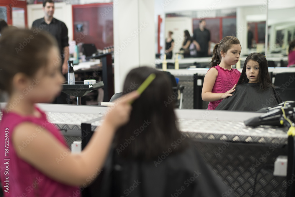 Little girls in hairdresser school