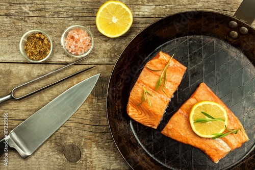 Frozen salmon on the kitchen table. Diet food. Home cooking fish. Steel kitchen pan.