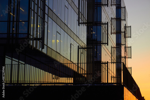 reflection of the light of the sky and sunset in a modern glass building