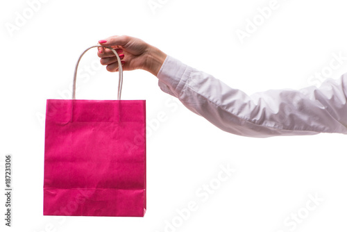 Hand holding shopping bags with christmas shopping on white back photo