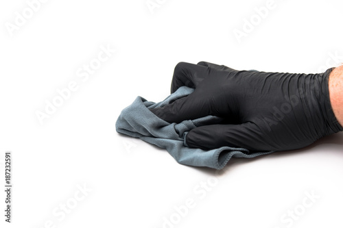 isolated hand with microfiber cloth and black disposable glove