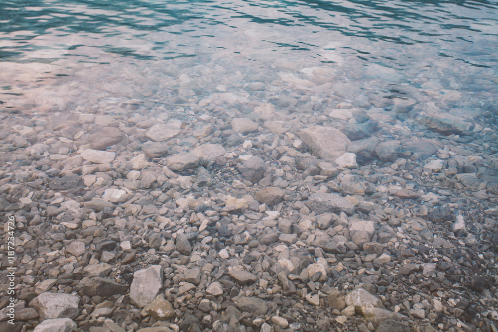 Italy view of the bottom of the beach mountain lake lago di ice in summer in cloudy weather