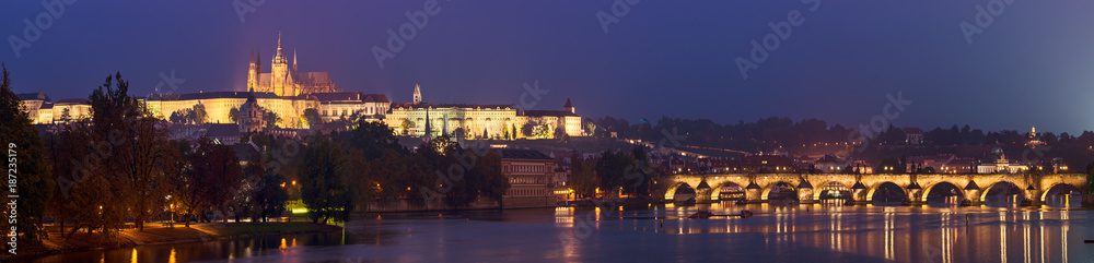 Fototapeta premium Night view of famous european Prague city - the capital of Czech republic with reflection in river Vltava and Charles Bridge. Panoramic view.