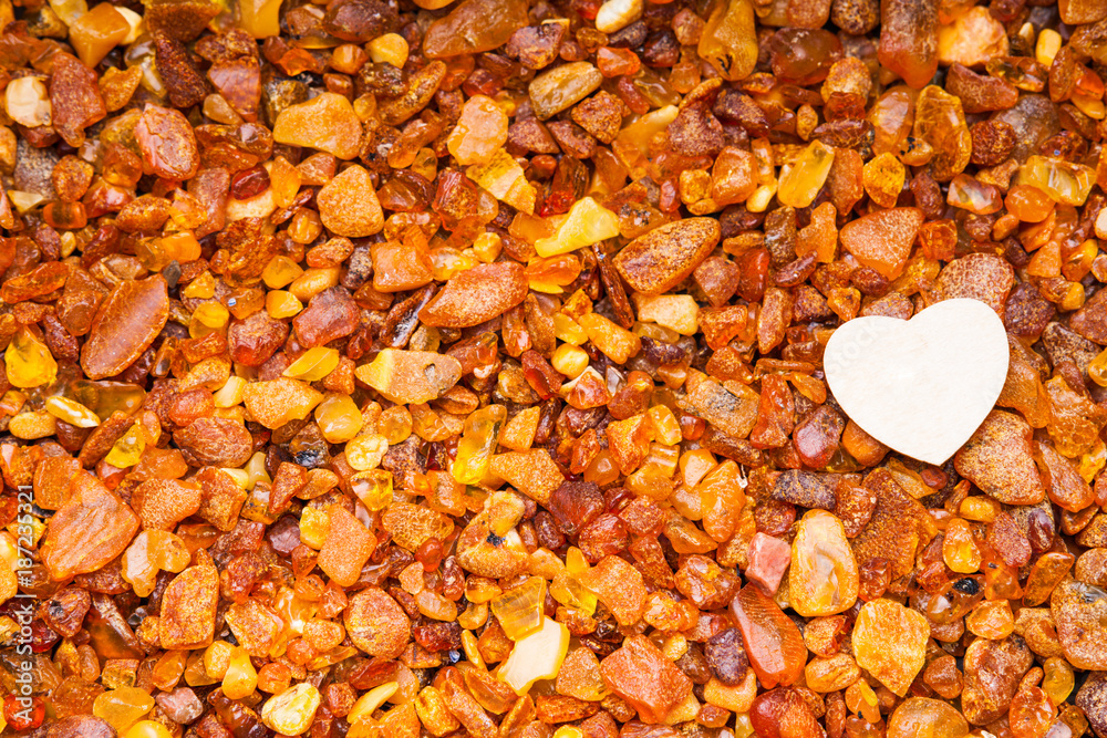 Amber stones and white heart shape Amber stones and white heart shape