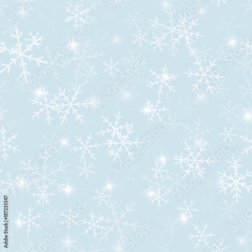 Magic snowflakes seamless pattern on light blue Christmas background. Chaotic scattered magic snowflakes. Ravishing Christmas creative pattern. Vector illustration.