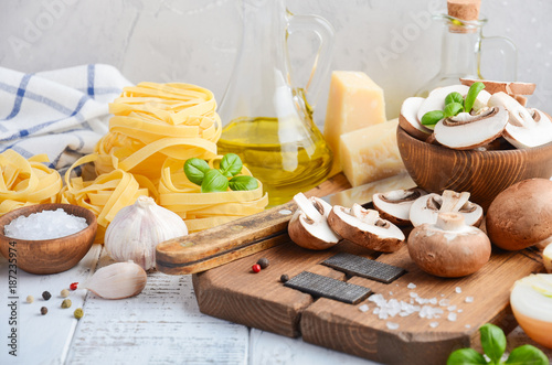 Ingredients for making tagliatelle pasta with mushrooms. Healthy Italian food. Selective focus.