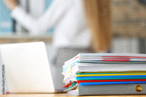 Stack of documents on office employee's table, closeup