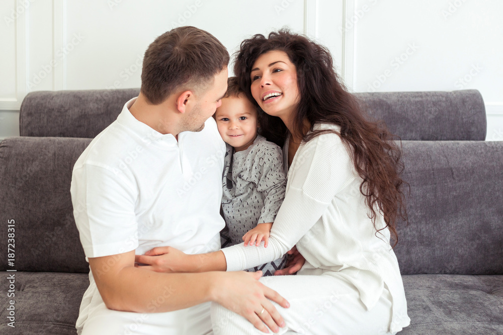 Young happy family, parenthood and people concept. Mother, father and child son at home spending time together Young happy family, parenthood and people concept. Mother, father and child son at home spending time together