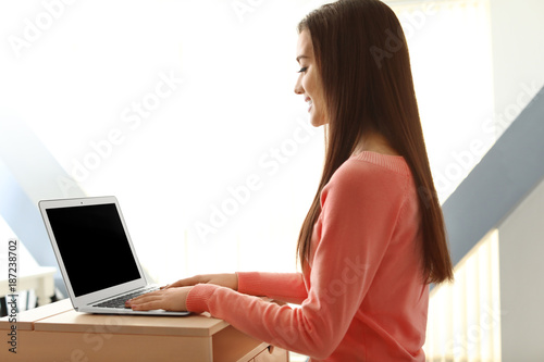 Young woman working with la...