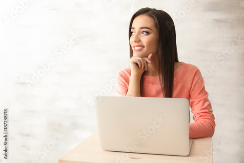 Young woman working with la...