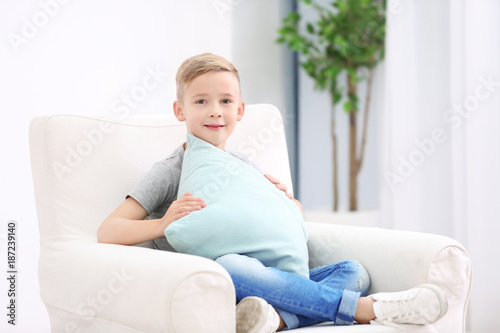 Cute boy with soft pillow a...