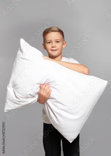 Cute boy with big pillow on...