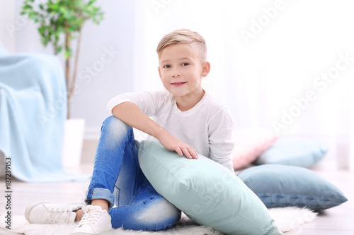 Cute boy with soft pillow a...