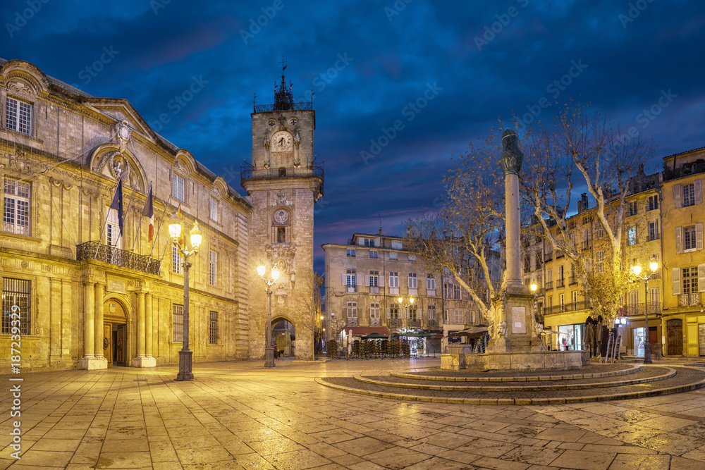 Town Hall square at dusk with City Hall (Hotel de Ville) building, clock tower and fountain in Aix-en-Provence, France